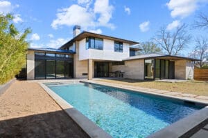 Modern home with pool and landscaping.