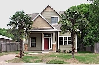 Two-story house with a red door.