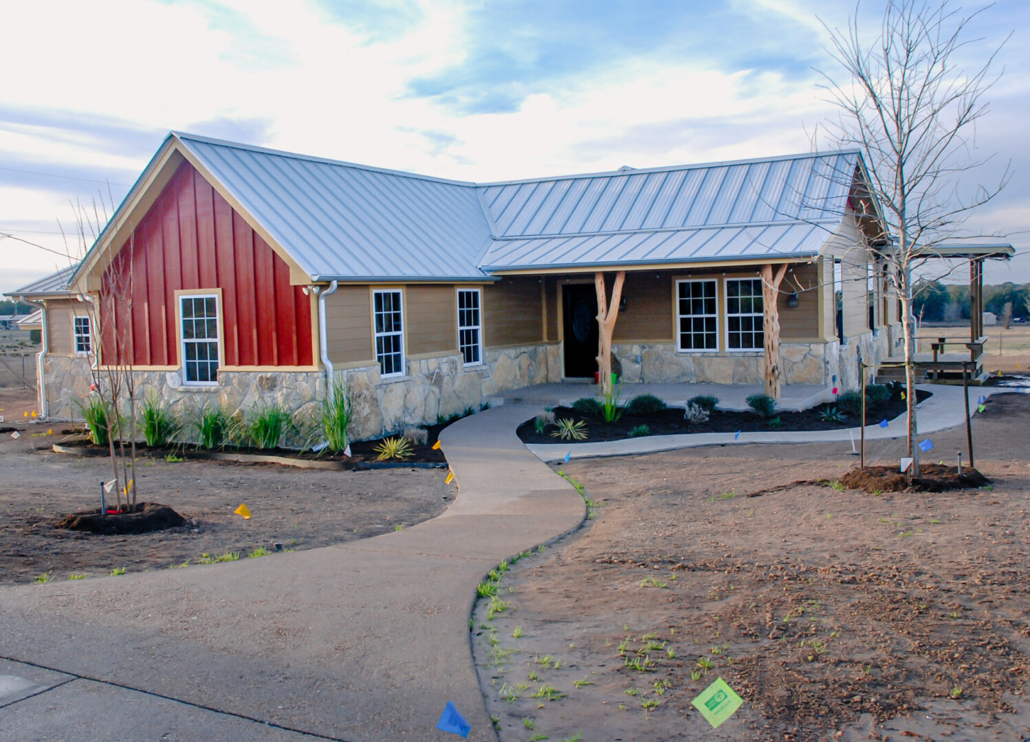 House with red siding and stone facade.