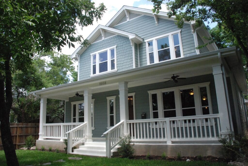 Gray house with white porch and railing.