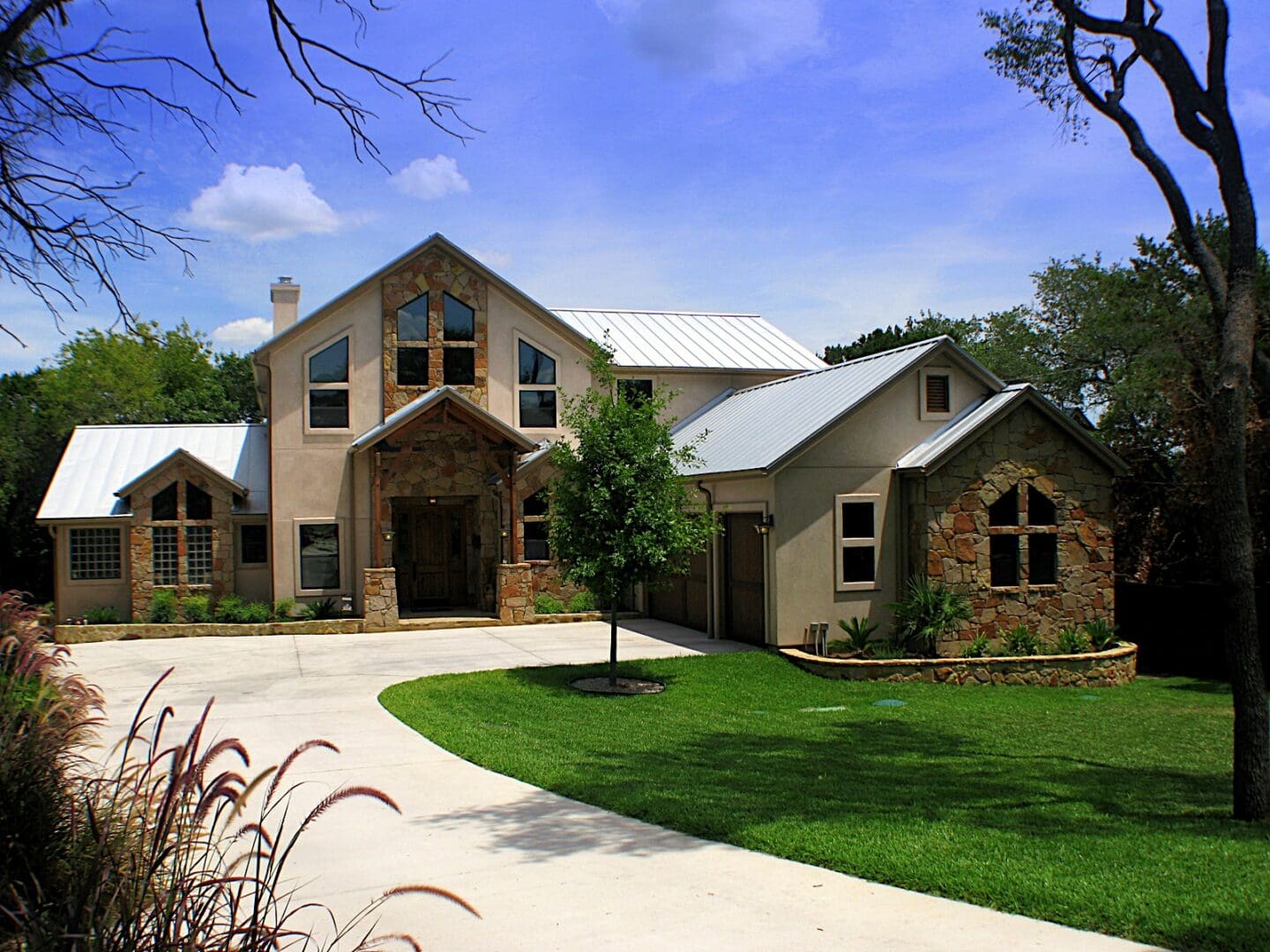 Stone and wood home with a driveway.